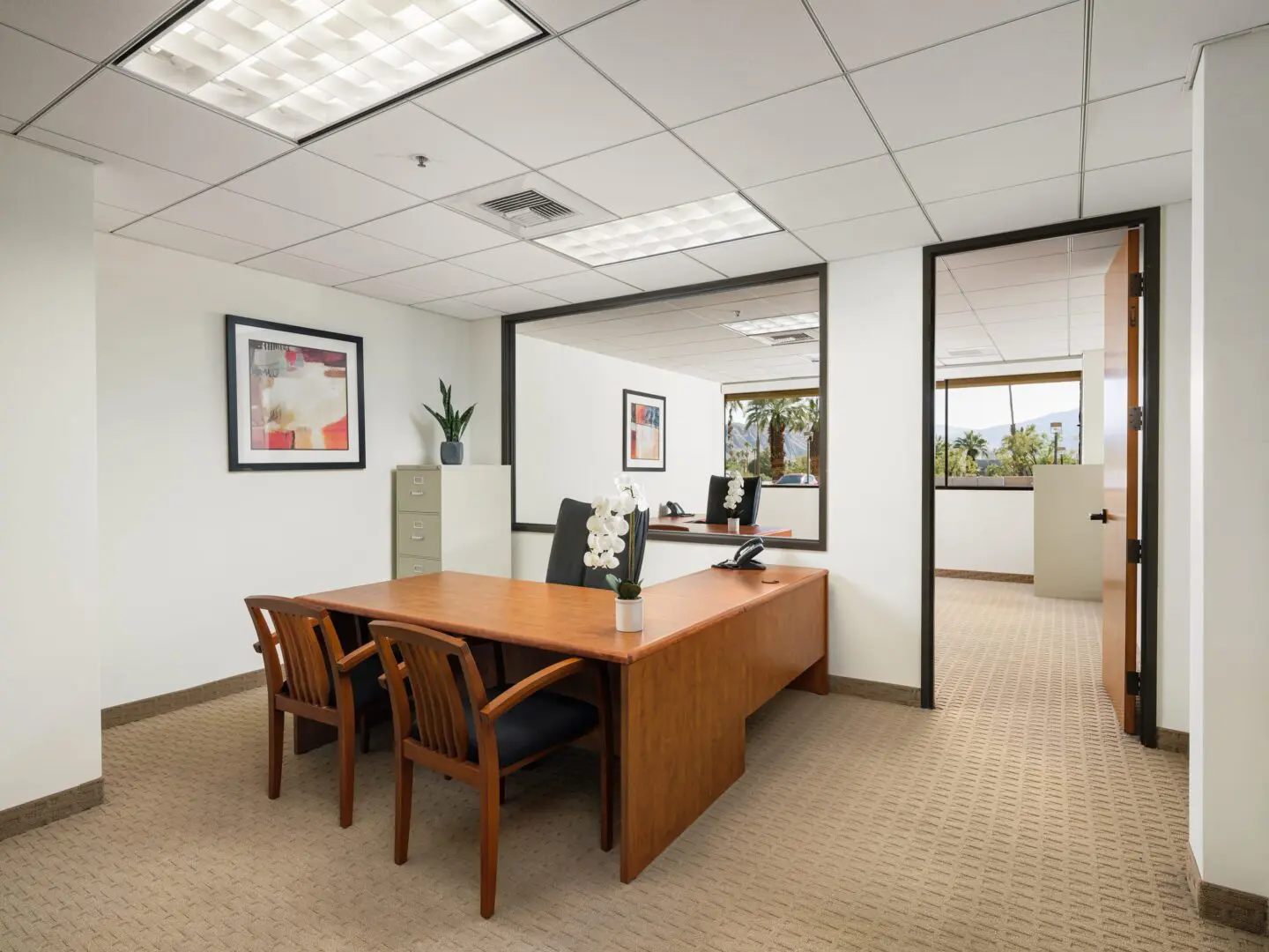 Empty office with wooden desk and chairs