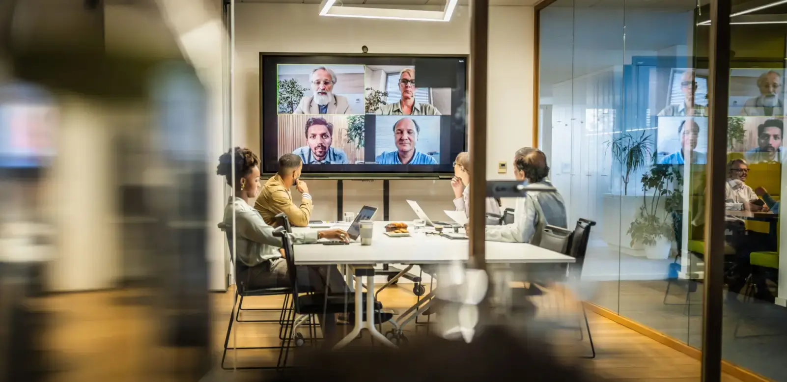 Office team watching four remote participants